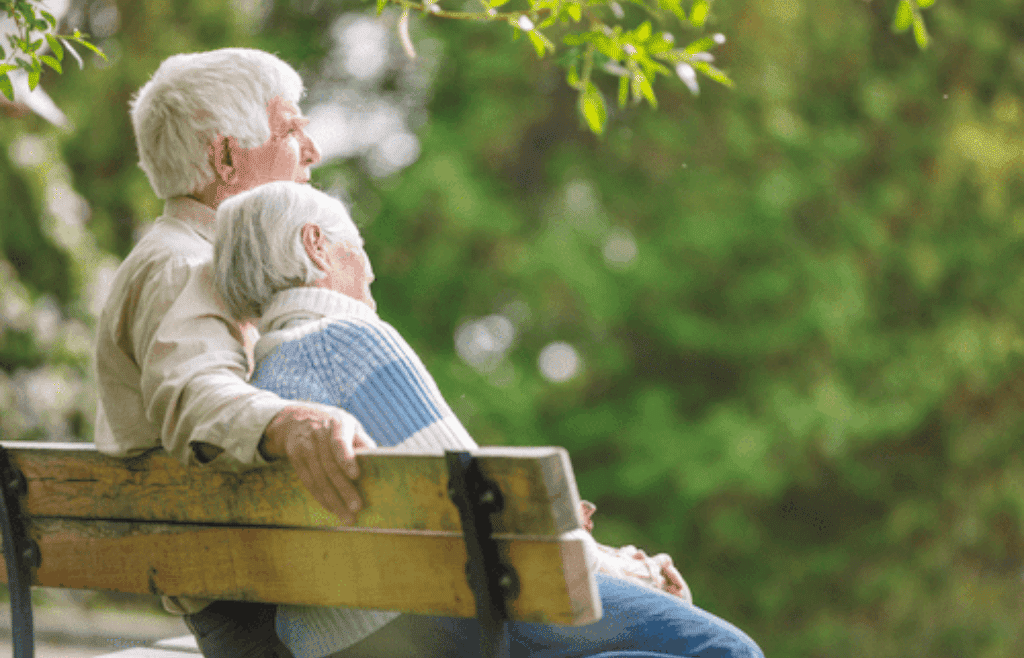 older couple sitting on bench
