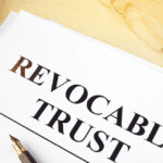 documents with the words "revocable trust" and a pen