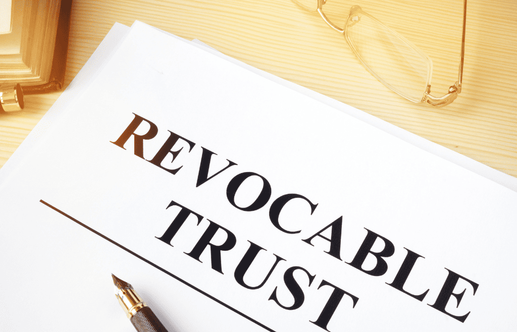 documents with the words "revocable trust" and a pen