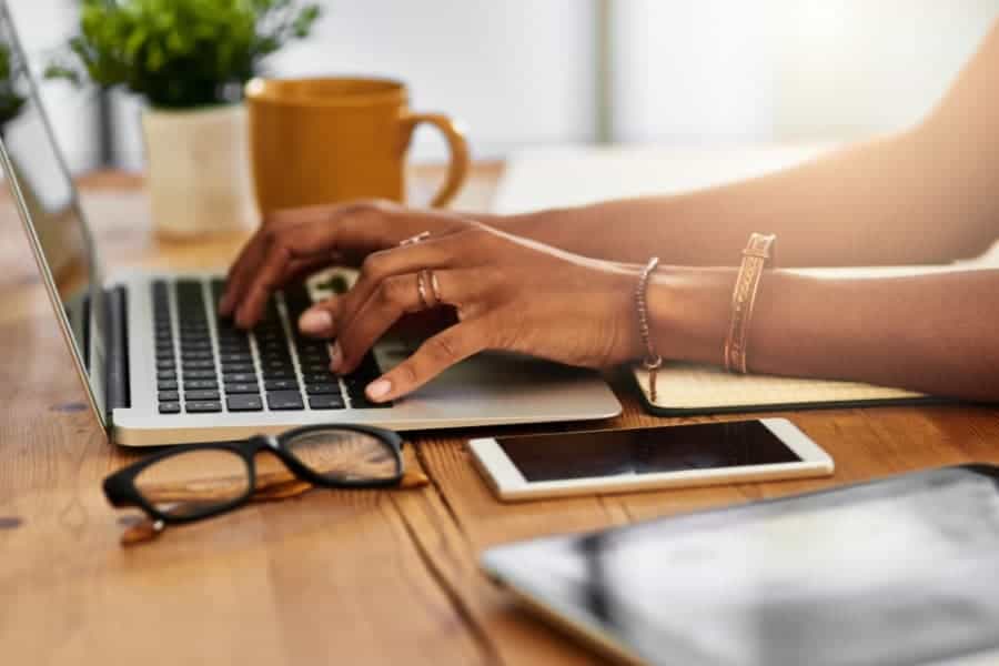 woman typing on laptop