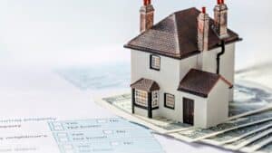 miniature home on money