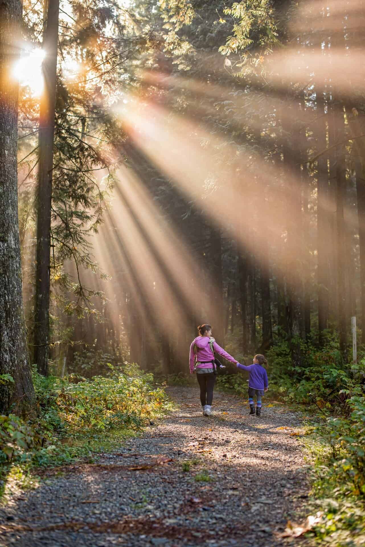 Woman hiking outdoors with daughter